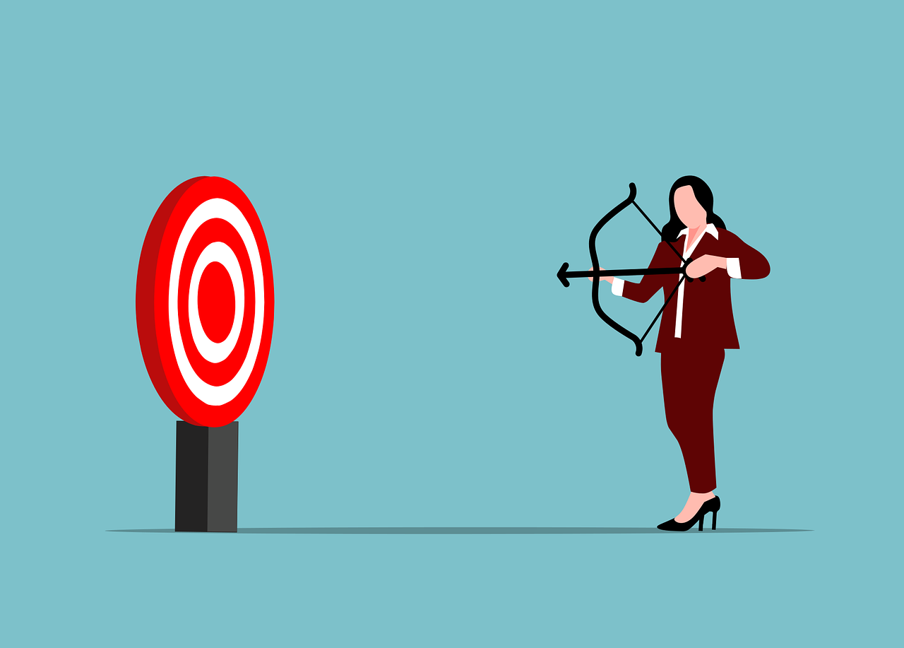 Business woman shooting an arrow